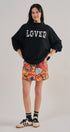LOVED Varsity Patch Mock Neck Sweatshirt with Exposed Seams in BLACK - Women's Sweatshirts & Hoodies | Urban Daizy