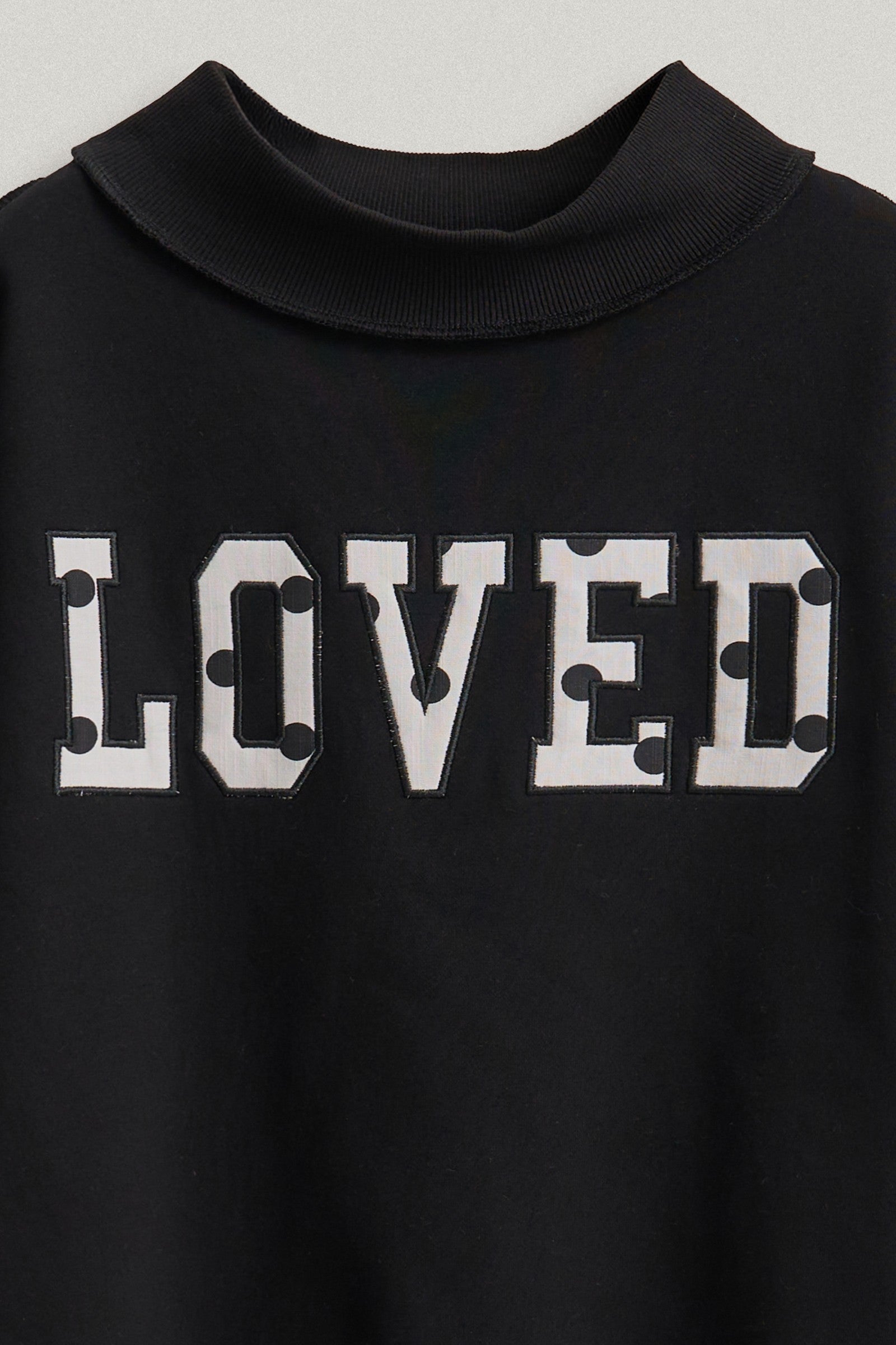 LOVED Varsity Patch Mock Neck Sweatshirt in Black - Women's Shorts | Urban Daizy