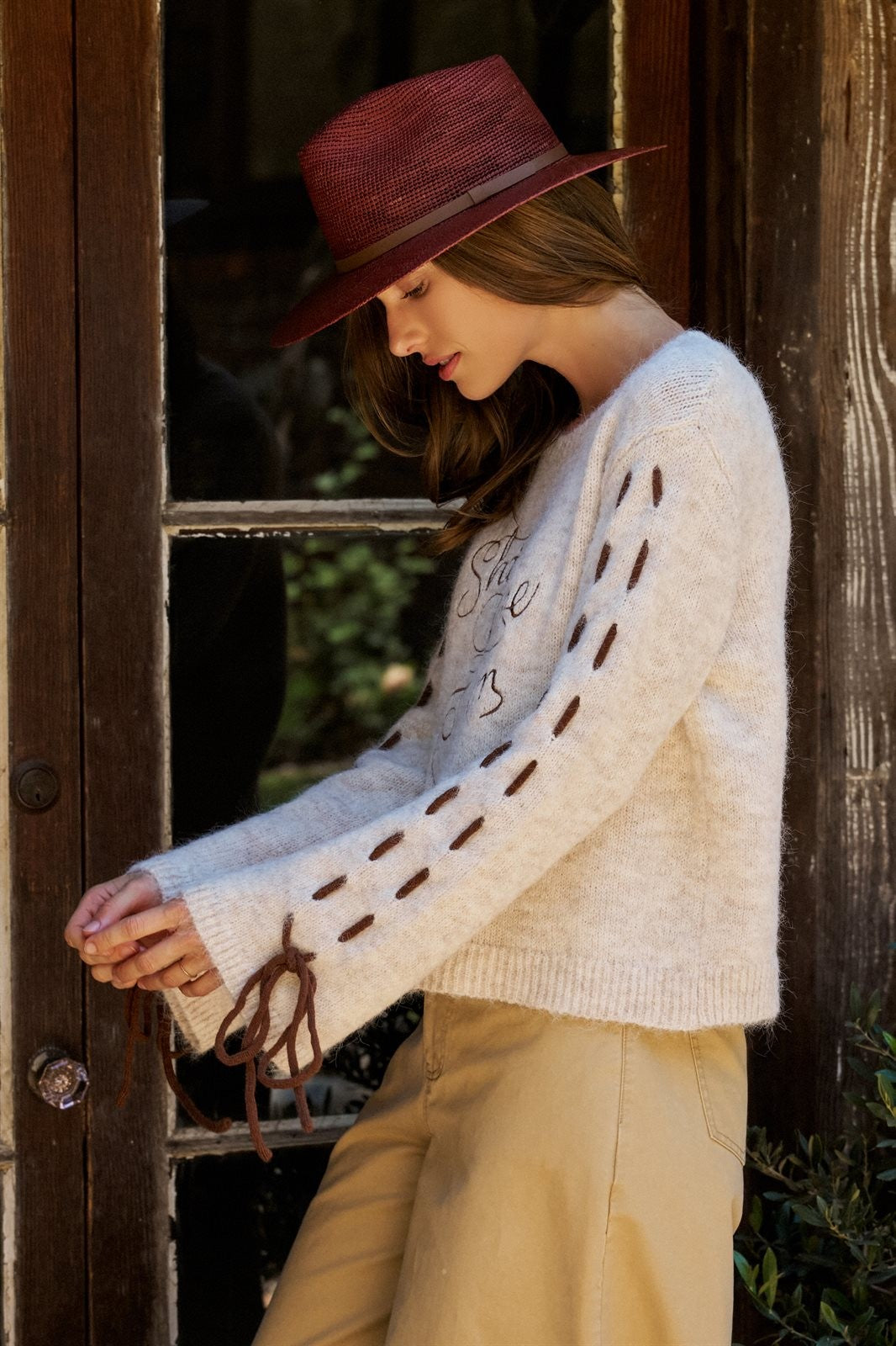 Slogan Embroidered Knit Sweater with Lace-Up Sleeves in Oatmeal - Women's Sweaters | Urban Daizy